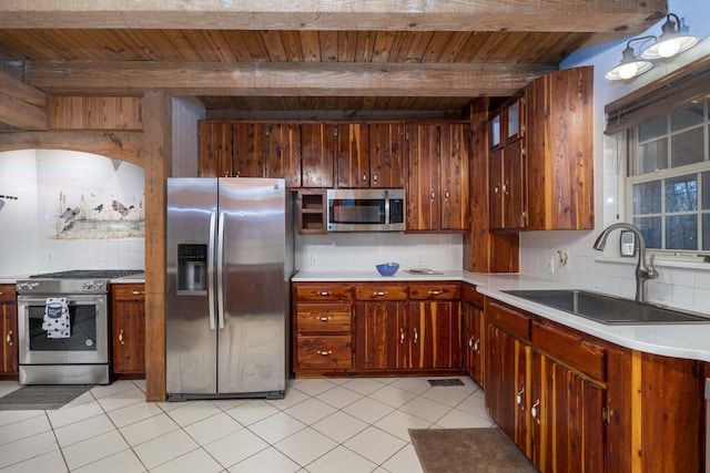 kitchen with sink, wooden ceiling, stainless steel appliances, beamed ceiling, and backsplash