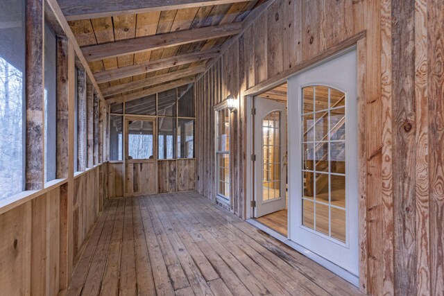 misc room featuring hardwood / wood-style flooring, vaulted ceiling with beams, wooden ceiling, and wooden walls