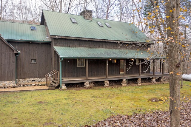 back of property featuring a yard