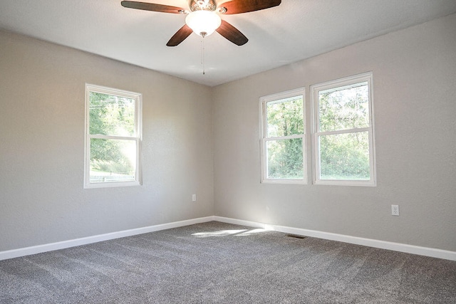 carpeted empty room with plenty of natural light and ceiling fan