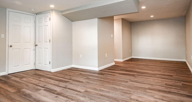 basement with hardwood / wood-style flooring