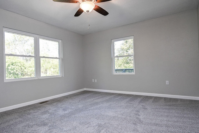 carpeted spare room with ceiling fan