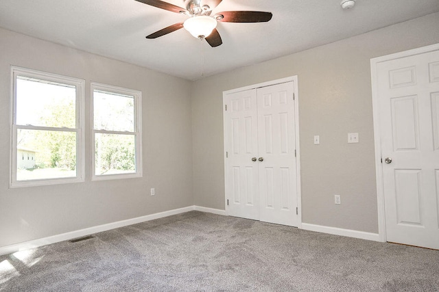 unfurnished bedroom featuring ceiling fan and carpet floors