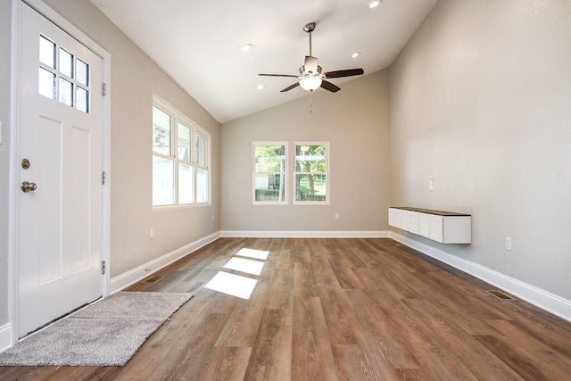 foyer entrance with hardwood / wood-style flooring, ceiling fan, and high vaulted ceiling