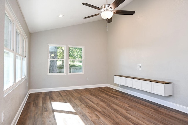 unfurnished room with dark hardwood / wood-style flooring, vaulted ceiling, and ceiling fan