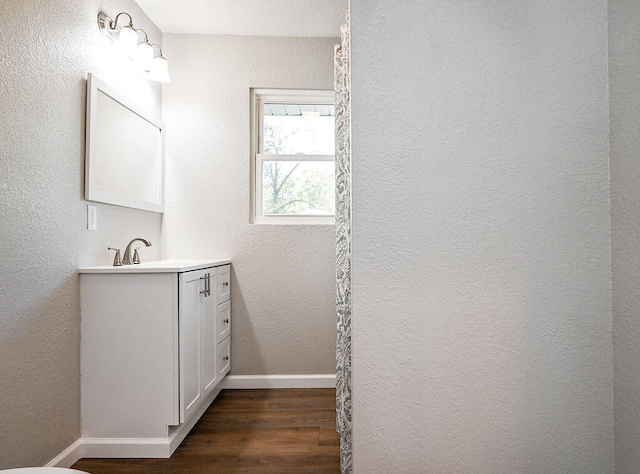 bathroom with vanity and hardwood / wood-style flooring