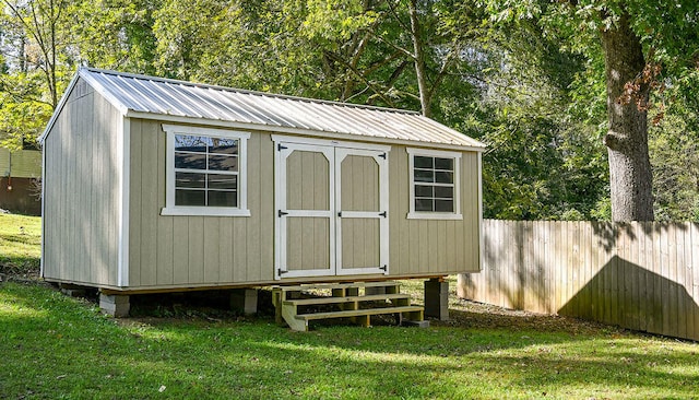 view of outdoor structure featuring a lawn