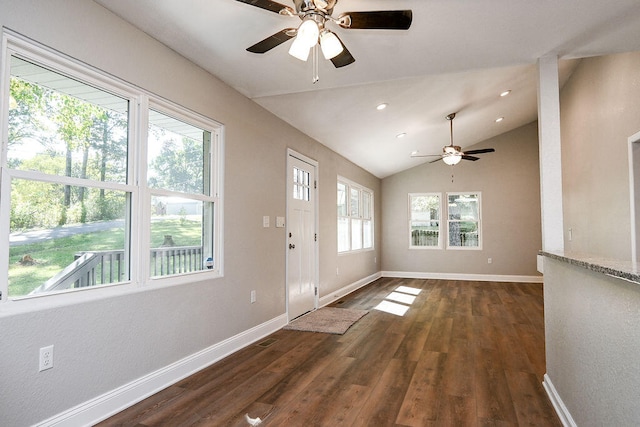 interior space with dark hardwood / wood-style flooring, vaulted ceiling, ceiling fan, and a healthy amount of sunlight