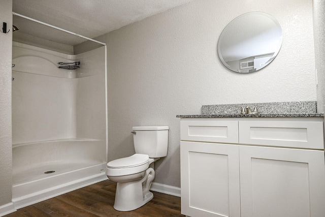 bathroom with vanity, hardwood / wood-style floors, a textured ceiling, and toilet