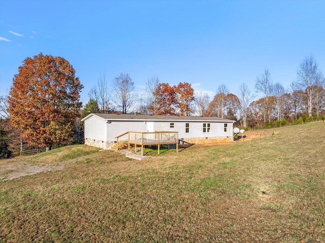 rear view of house with a yard and a wooden deck