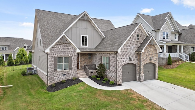 view of front facade featuring a front yard, central AC, and a garage