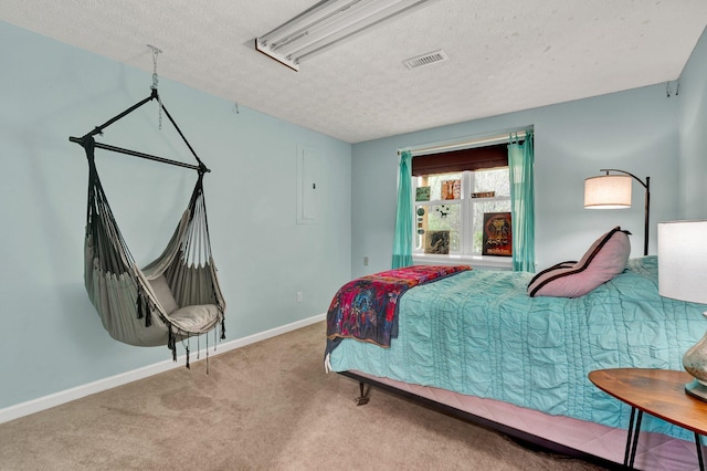 carpeted bedroom featuring visible vents, baseboards, and a textured ceiling