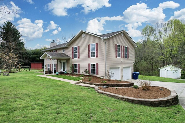 view of front facade with an outdoor structure, a front yard, an attached garage, a chimney, and concrete driveway