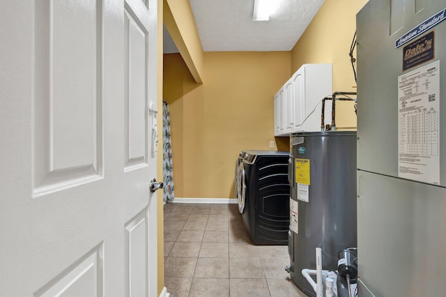 laundry area featuring electric water heater, baseboards, light tile patterned flooring, cabinet space, and washing machine and clothes dryer