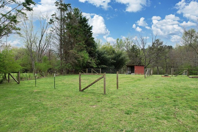 view of yard with an outbuilding and fence