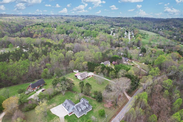 drone / aerial view featuring a view of trees