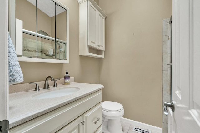 bathroom featuring visible vents, baseboards, toilet, vanity, and tile patterned flooring