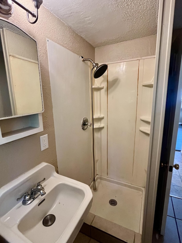 201 S Facy St, Rockwood, TN 37854 - full bath featuring a sink, walk in shower, a textured ceiling, a textured wall, and tile patterned floors