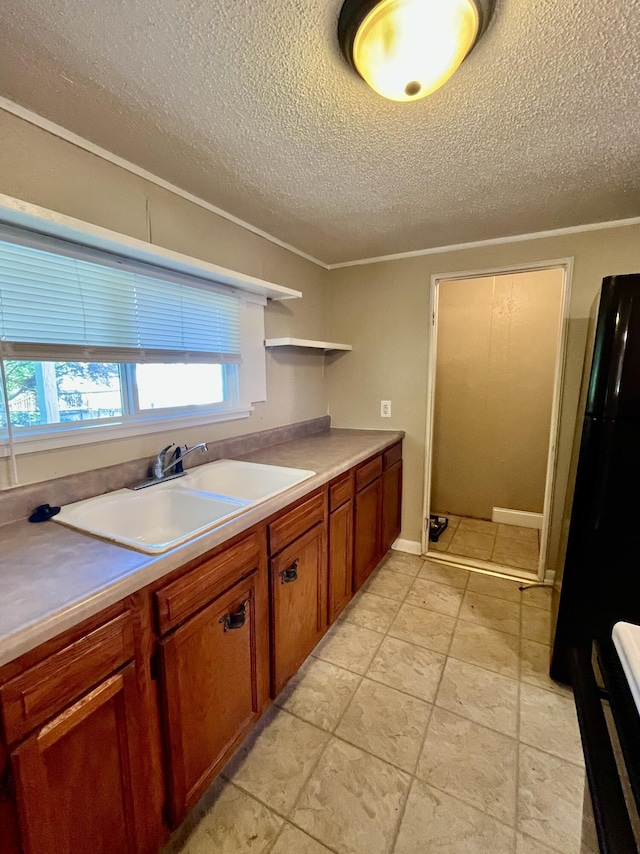 201 S Facy St, Rockwood, TN 37854 - kitchen featuring freestanding refrigerator, a textured ceiling, brown cabinetry, a sink, and open shelves