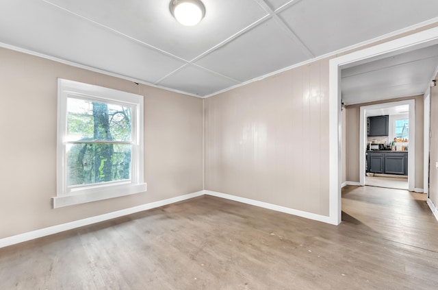 spare room featuring crown molding and wood-type flooring