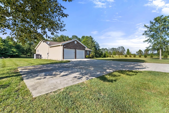 view of home's exterior with driveway, a garage, and a lawn