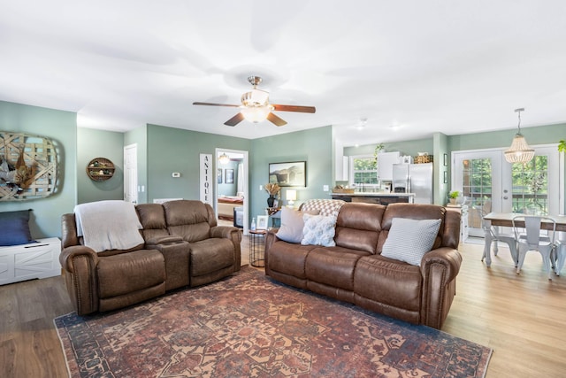 living room featuring a ceiling fan and wood finished floors