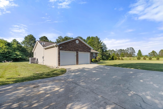 view of home's exterior featuring cooling unit, a lawn, and driveway