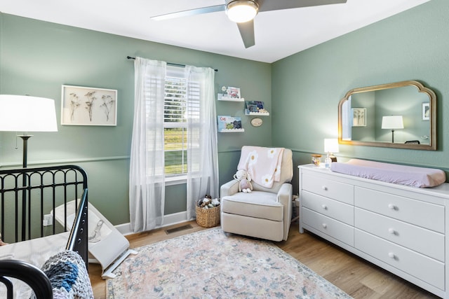 bedroom with visible vents, a ceiling fan, and wood finished floors