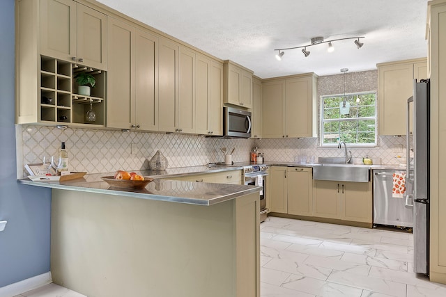 kitchen featuring backsplash, sink, a textured ceiling, kitchen peninsula, and stainless steel appliances