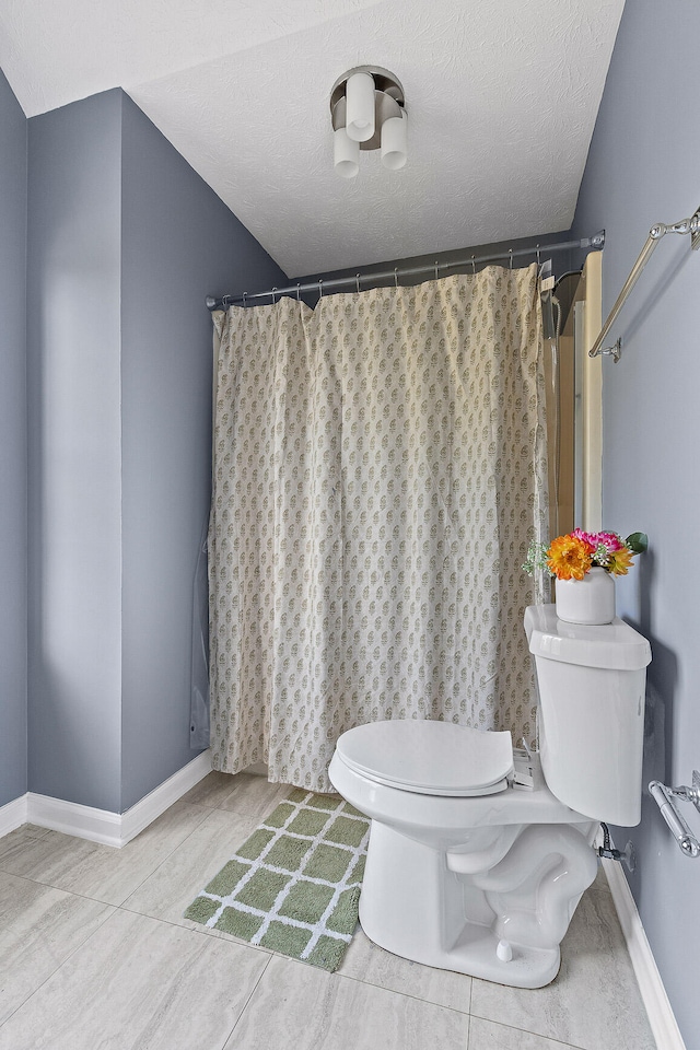 bathroom featuring hardwood / wood-style floors, a textured ceiling, and toilet