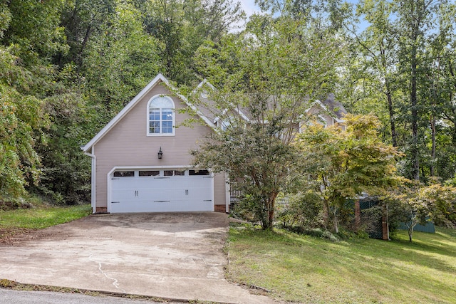 view of front of property with a garage and a front lawn