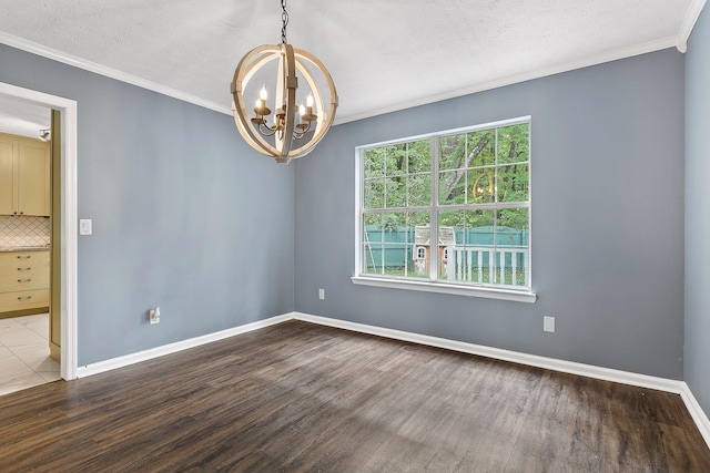 spare room featuring ornamental molding, a chandelier, a textured ceiling, and hardwood / wood-style flooring