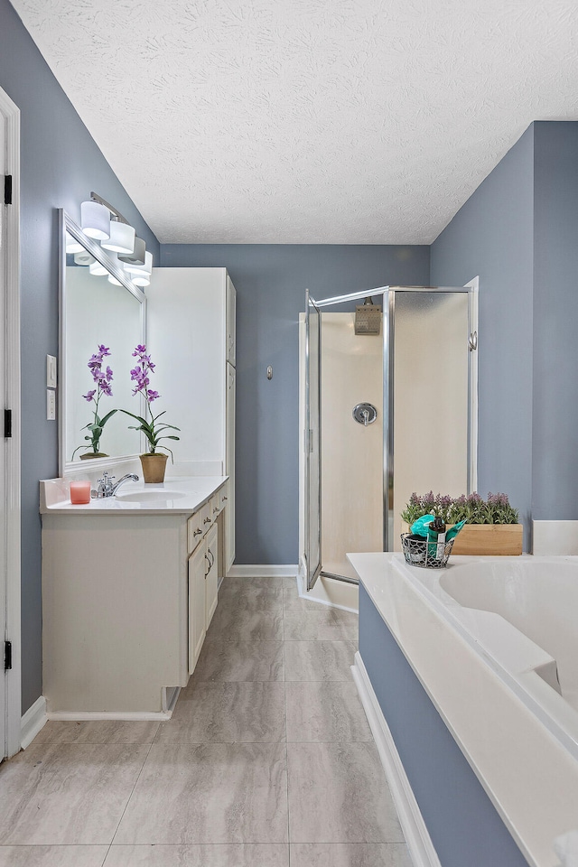 bathroom with separate shower and tub, tile patterned flooring, vanity, and a textured ceiling