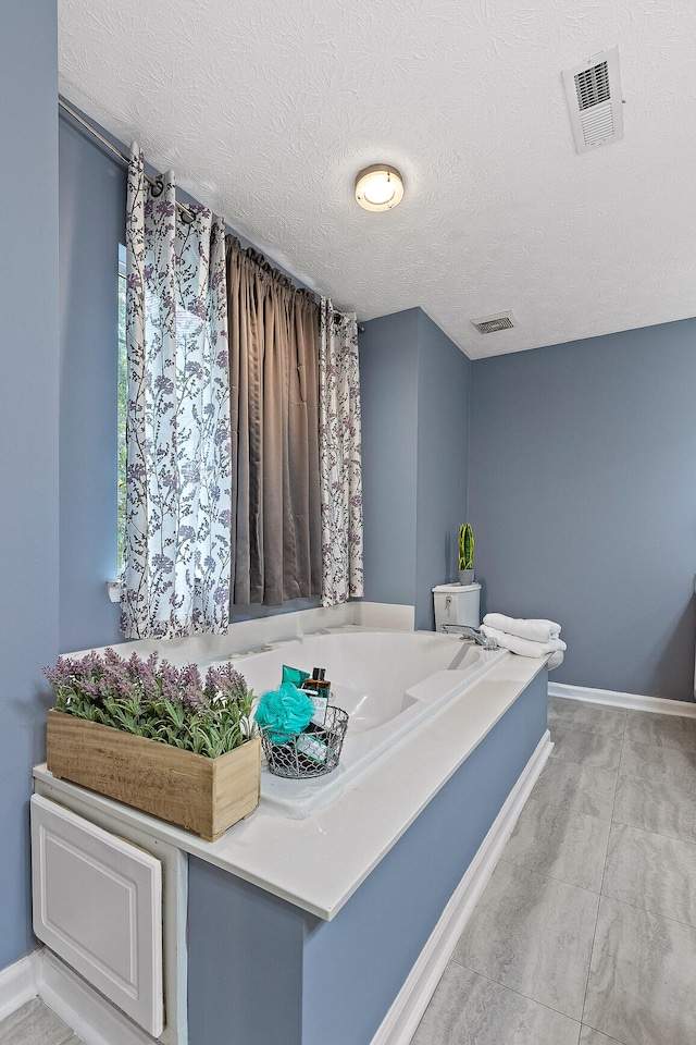 bathroom with a textured ceiling