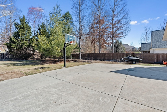 view of basketball court featuring fence and basketball court