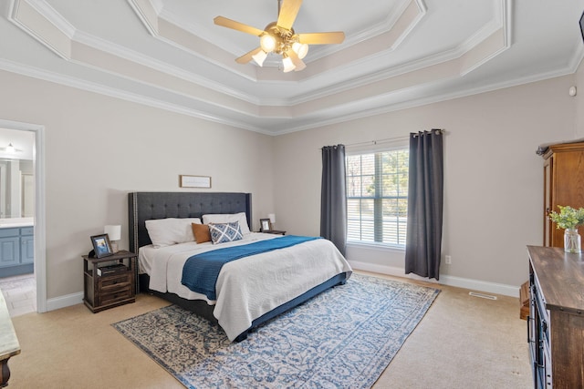 bedroom featuring a tray ceiling, light carpet, and baseboards