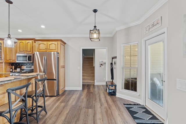 kitchen with crown molding, light wood finished floors, stainless steel appliances, decorative backsplash, and glass insert cabinets