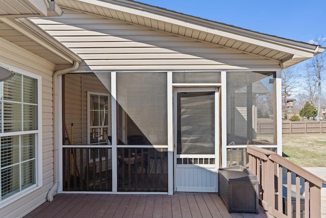 wooden terrace with a sunroom and fence
