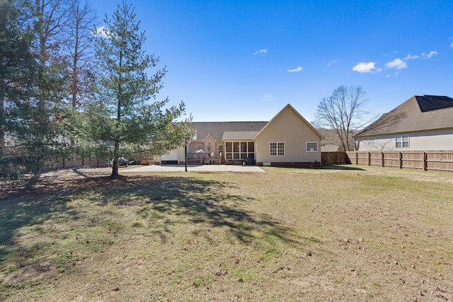 back of house with a patio area, fence, and a lawn