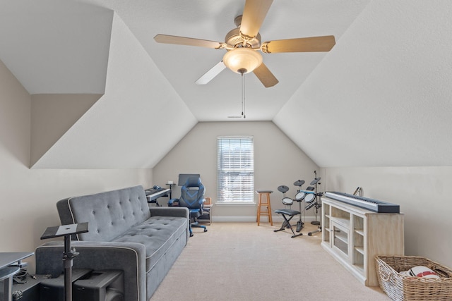 interior space featuring carpet, baseboards, vaulted ceiling, and a ceiling fan