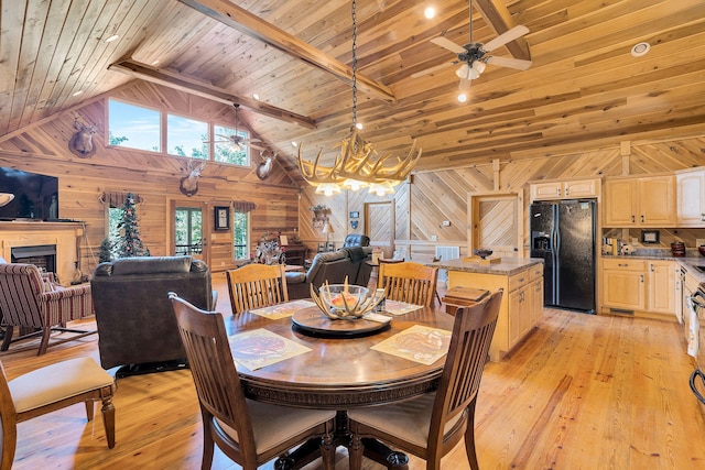 dining area featuring ceiling fan with notable chandelier, wooden walls, light hardwood / wood-style flooring, and wooden ceiling