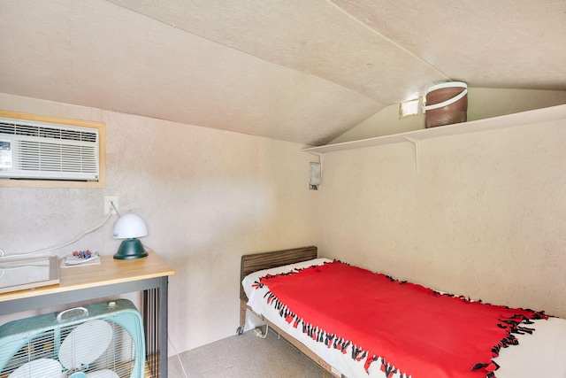 bedroom with a wall mounted air conditioner and lofted ceiling