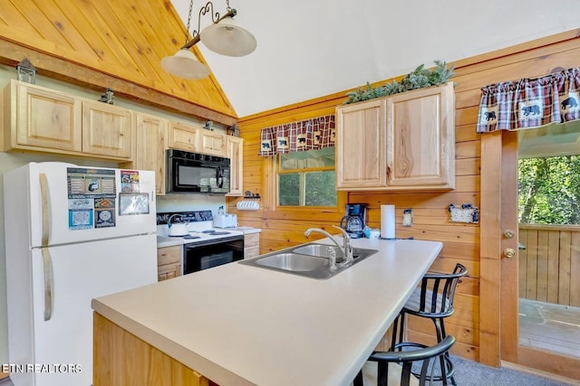 kitchen featuring light brown cabinets, white appliances, sink, and wooden walls