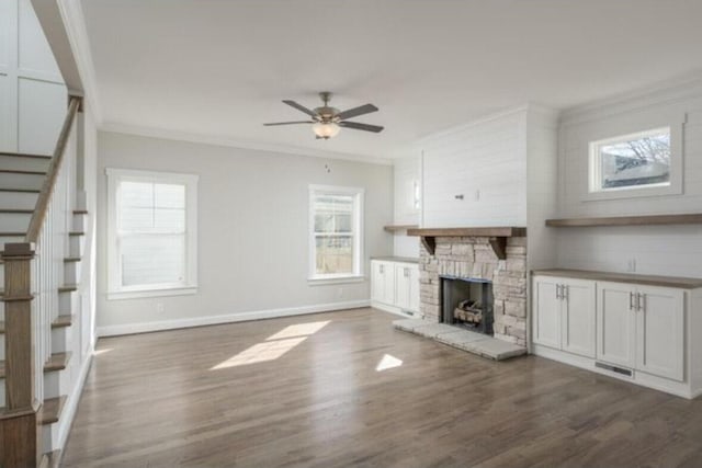 5013 Solar Ln NW, Cleveland, TN 37312 - unfurnished living room featuring crown molding, stairs, dark wood-style flooring, a ceiling fan, and plenty of natural light