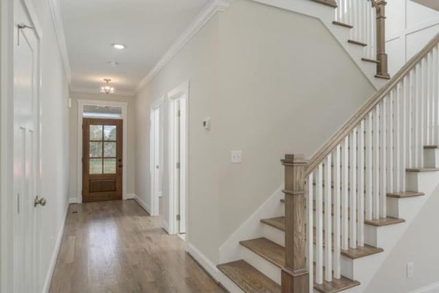 5013 Solar Ln NW, Cleveland, TN 37312 - foyer entrance featuring crown molding, stairs, wood finished floors, and baseboards