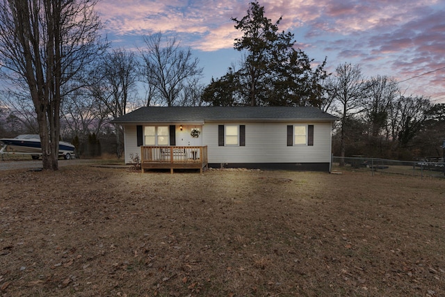 view of front of house featuring a lawn and a deck