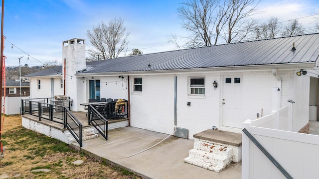 back of property with a patio