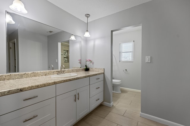 bathroom featuring toilet and vanity