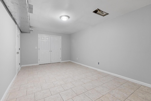 unfurnished bedroom featuring a closet and light tile patterned flooring