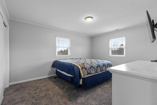 carpeted bedroom featuring ornamental molding and a textured ceiling